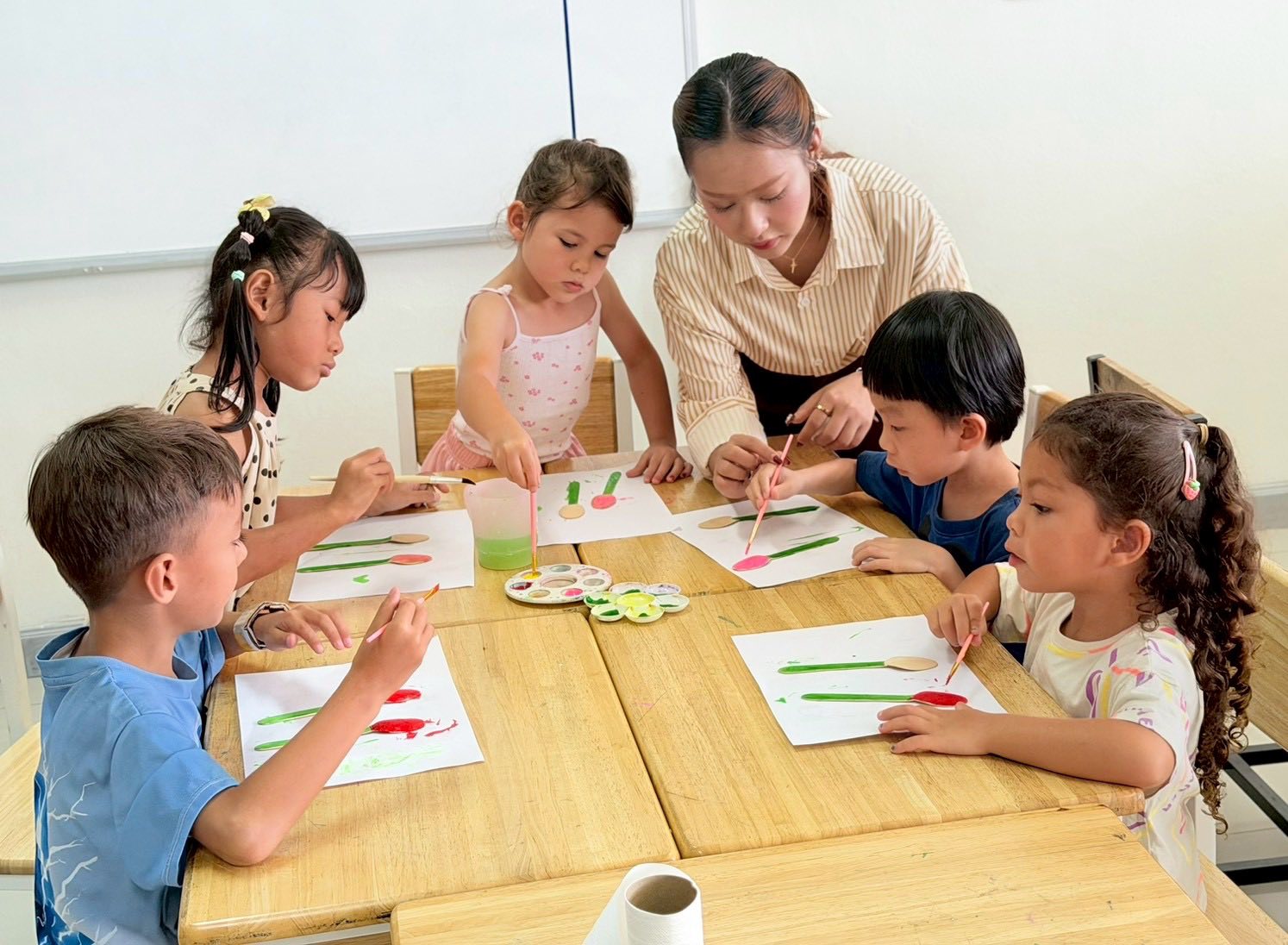 Children painting together in an art lesson at Sethavidhya School Hua Hin