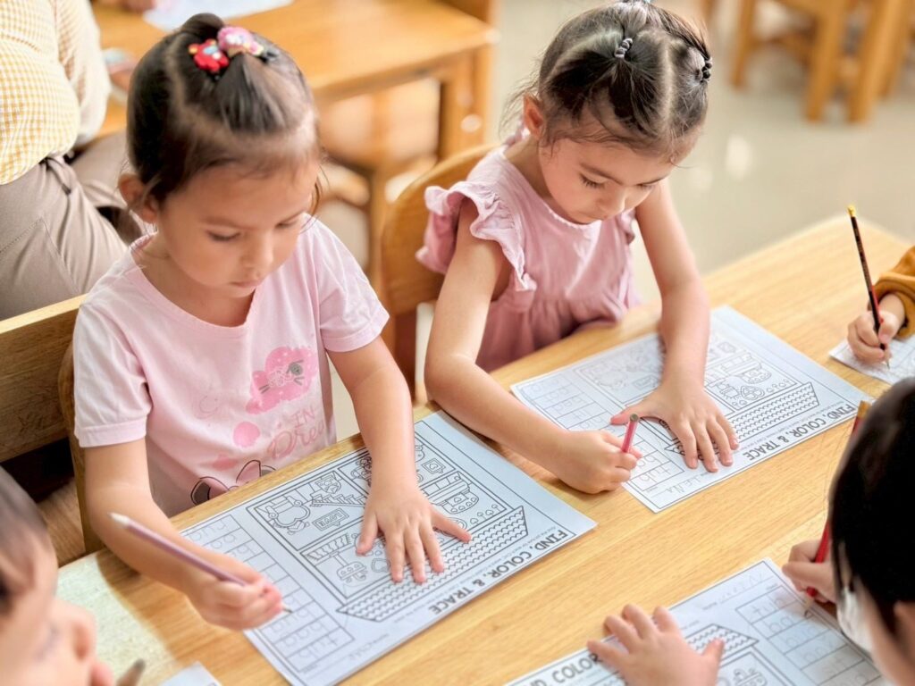 Girls working on a worksheet together in class